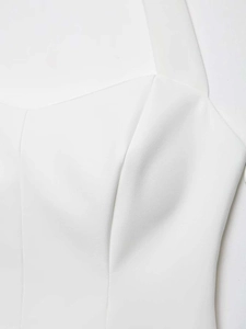 Detailed view of the sweetheart neckline and pleated texture on white summer tank top