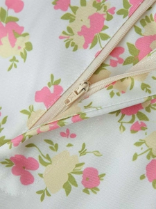 Detail shot of invisible beige nylon zipper on floral print summer wide leg pants set
