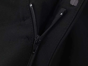 Detail of high-quality metal zipper and twill fabric texture on elegant black blazer suit