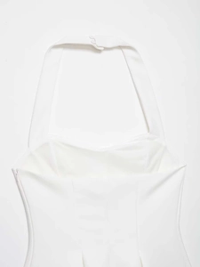 Detail view of white halter neck top with hidden side zipper and back button closure