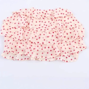 Sweet pink girls' tiered cake skirt with vibrant red polka dots in airy chiffon