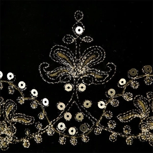 Velvet vest with gold sequin embroidery and floral patterns on black fabric