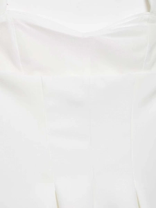 Detailed view of the white halter top featuring vertical princess seams and slim fit tailoring