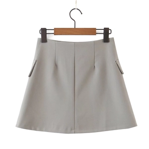 Detail view of light gray high-waisted A-line skirt with structured suit fabric and pockets