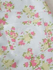 Close-up of floral print fabric featuring a clean rectangular pocket and pink flower pattern