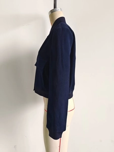 Detail view of navy blue short bomber jacket with ribbed trim on a mannequin