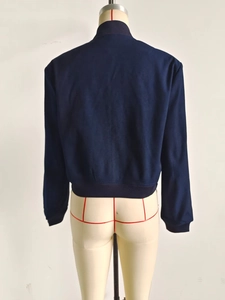 Rear view of a dark blue suede bomber jacket with ribbed collar and cuffs on a mannequin