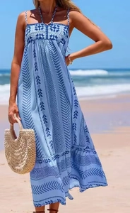 Detail of bohemian blue crochet maxi dress with intricate embroidery and halter straps