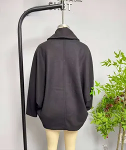 Back view of a black wool blend coat with wide sleeves and clean minimalist stitching