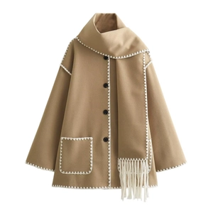 Detail of wool coat with scarf collar, white tassel trim and wavy contrast stitching