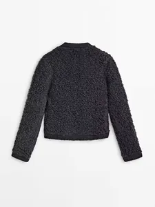 Detailed back view of dark grey textured bouclé knit cardigan with ribbed hem and cuffs