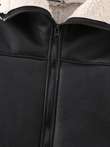 Détail d'une veste noire en similicuir avec doublure en peau de mouton et zip métallique