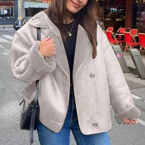 Street style shot of a grey faux shearling suede jacket with plush collar and cuffs