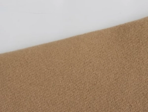 Close-up of camel wool blend fabric showing thick woven texture and fiber details