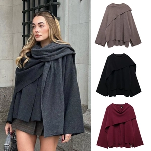 Detail view of knitted poncho coat with asymmetrical scarf collar in multiple color options