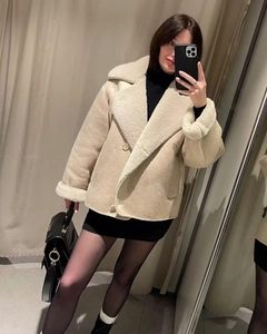 Close-up of faux suede shearling jacket with warm fleece lining and button closure