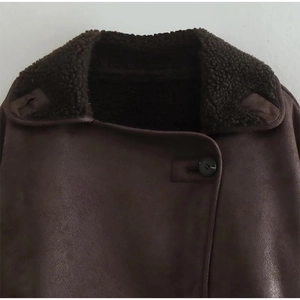 Detail of dark brown faux suede jacket featuring a warm shearling collar and button closure