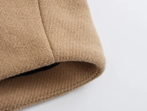 Detailed macro view of camel wool blend fabric texture with high-quality inner lining