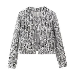 Close-up of sparkling silver sequins on women's tweed jacket with elegant round neckline