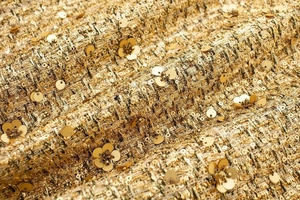 Detail of golden tweed jacket with metallic sequins and 3D floral applique texture