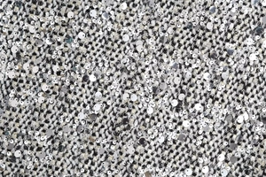 Macro shot of high-quality sequined black and white tweed fabric for women's jackets