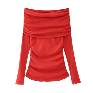 Detail of red off-shoulder long sleeve top with elegant pleated neckline and ruched sides
