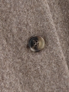 Macro shot of texture wool fabric and marble pattern button on winter coat
