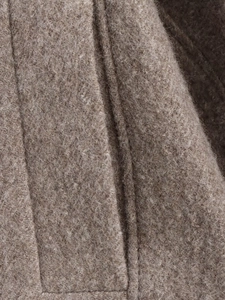 Close-up of thick camel wool fabric texture with detailed stitching for winter coat