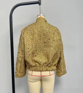 Detailed back view of a sequined gold jacket with stand collar and metallic texture