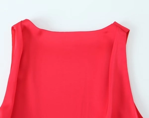 Detail of red sleeveless satin top featuring a smooth round neckline and high-quality texture