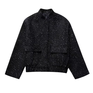 Detail of black tweed jacket with silver sequins, stand collar and large flap pockets