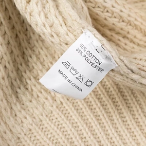 Close-up of garment wash label showing 65% cotton and 35% polyester fabric blend