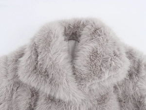 Détail macro de la texture de fausse fourrure gris clair d'un manteau d'hiver moelleux