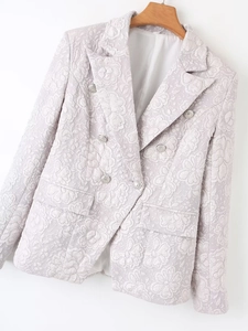 Detail of lavender double-breasted blazer with embossed floral texture and silver buttons