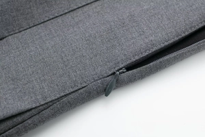 Detailed macro shot of the invisible zipper closure on the grey blended pleated skirt