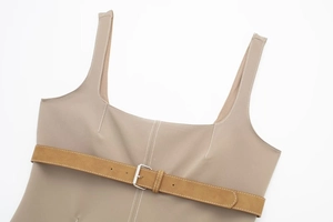 Detail of khaki top with white contrast stitching and brown faux suede belt buckle