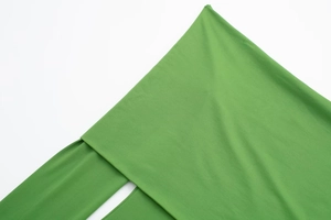 Close-up detail of green nylon blend fabric showing fine knitted texture and material quality
