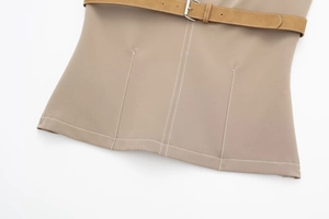 Detail of khaki skirt waist featuring brown suede belt and white contrast stitching