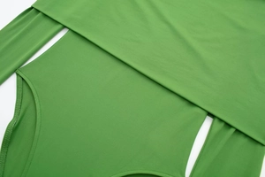 Close-up of grass green long sleeve bodysuit featuring hollow-out waist details