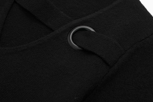 Detail of black knit fabric featuring metallic eyelets and criss-cross strap design