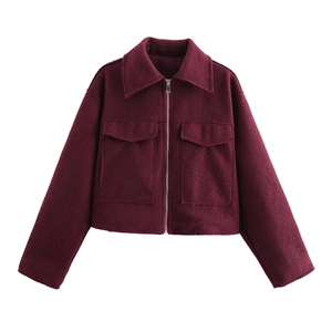 Close-up of burgundy tweed cropped jacket featuring flap pockets and silver metal zipper