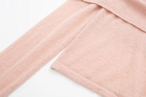 Close-up of pink knit top fabric showing soft texture and fine stitching details