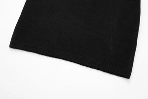 Detail shot of the black knit dress hem showing fine ribbed edges and cashmere texture