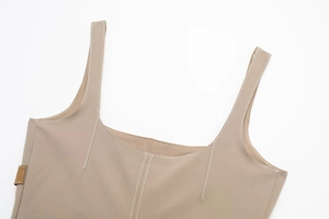 Detailed close-up of khaki tank top featuring contrast stitching and a small brown label