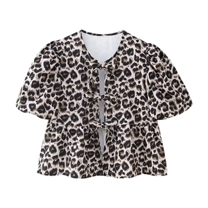 Detail of leopard print top with three front bow ties and ruffled hemline
