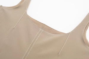 Macro shot of khaki top featuring white contrast stitching and high-quality elastic fabric