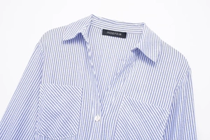 Close-up of blue striped shirt dress detailing collar, front pockets and button closure