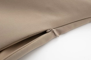 Detailed close-up of invisible zipper and woven khaki fabric texture on the top