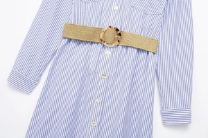 Detailed view of striped shirt dress with a khaki woven belt and tortoise shell buckle