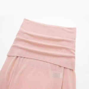Pink knit long sleeve top with elegant boat neck design and soft ribbed fabric texture